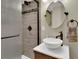 Beautiful bathroom with tiled shower, vessel sink, and bronze fixtures at 10882 Bullock Ct, Parker, CO 80134