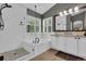 Bright bathroom featuring white subway tiles, a walk-in shower, and a luxurious soaking tub at 10882 Bullock Ct, Parker, CO 80134