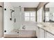Bright bathroom features a soaking tub, glass shower with tiled walls, and a vanity with a vessel sink at 10882 Bullock Ct, Parker, CO 80134