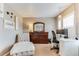 Comfortable bedroom with ample natural light, a work space, and a lounger at 10882 Bullock Ct, Parker, CO 80134