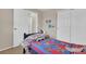 A bedroom featuring a playful quilt and convenient closet space at 10882 Bullock Ct, Parker, CO 80134