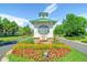 Welcoming community sign surrounded by colorful flowers and lush greenery at 10882 Bullock Ct, Parker, CO 80134