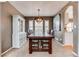 Dining room features a large wooden table with seating for six and a modern light fixture at 10882 Bullock Ct, Parker, CO 80134