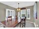 Dining room showcases a large wooden table, ornate light fixture, and elegant wall decor at 10882 Bullock Ct, Parker, CO 80134
