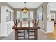 Dining room with a large wooden table, decorative light fixture, and built-in display cabinet at 10882 Bullock Ct, Parker, CO 80134