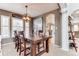 Formal dining room with modern lighting and a view of the open concept living area at 10882 Bullock Ct, Parker, CO 80134