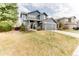 Charming two-story blue home with a well-manicured lawn and attached gray two-car garage at 10882 Bullock Ct, Parker, CO 80134