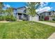 Charming two-story home boasting blue siding, stone accents, lush lawn, and mature trees at 10882 Bullock Ct, Parker, CO 80134
