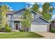 Charming two-story home featuring a blue exterior, stone accents, and a well-manicured lawn at 10882 Bullock Ct, Parker, CO 80134