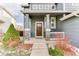 Charming home featuring a wood front door, stone accents, and a cozy covered porch area at 10882 Bullock Ct, Parker, CO 80134