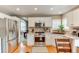 Bright kitchen featuring stainless steel appliances, white cabinets, and granite countertops at 10882 Bullock Ct, Parker, CO 80134