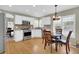 Bright kitchen with stainless steel appliances, white cabinets, and adjacent dining area at 10882 Bullock Ct, Parker, CO 80134