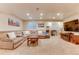 Spacious living room with a large sectional couch, TV, and neutral decor at 10882 Bullock Ct, Parker, CO 80134