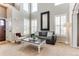 Bright living room with soaring ceilings, plantation shutters and neutral decor at 10882 Bullock Ct, Parker, CO 80134