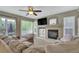 Comfortable living room with a fireplace, large windows, and sliding door access to backyard at 10882 Bullock Ct, Parker, CO 80134
