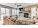 Cozy living room features a fireplace, ceiling fan, and a sliding glass door to the patio at 10882 Bullock Ct, Parker, CO 80134