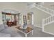 Spacious living room open to the dining area, featuring neutral tones and a staircase at 10882 Bullock Ct, Parker, CO 80134
