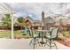 Backyard patio features a dining set under a pergola and a playset in the background on green grass at 10882 Bullock Ct, Parker, CO 80134