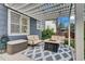 Inviting patio with pergola, featuring stylish seating and a cozy fire pit on a patterned rug at 10882 Bullock Ct, Parker, CO 80134