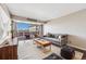 Inviting living room featuring modern furniture, hardwood floors, and expansive windows with a balcony and city views at 1121 Albion St # 803, Denver, CO 80220