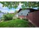 Side view of backyard featuring a shed, privacy fence and lush lawn at 850 Idalia Cir, Aurora, CO 80011