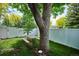 A fenced-in backyard with a picnic table under the shade of mature trees at 850 Idalia Cir, Aurora, CO 80011