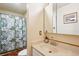 Bathroom featuring a shower with a floral curtain, vanity sink, mirror, and tile flooring at 850 Idalia Cir, Aurora, CO 80011