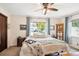 Bright and airy bedroom with a large window, ceiling fan, and comfortable furnishings at 850 Idalia Cir, Aurora, CO 80011