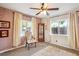 Cozy bedroom features natural light, ceiling fan, and comfortable furnishings at 850 Idalia Cir, Aurora, CO 80011