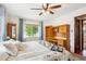 Comfortable bedroom with a large window, ceiling fan, and traditional furnishings at 850 Idalia Cir, Aurora, CO 80011