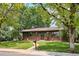 Charming single-story home with lush front yard, brick accents, and mature trees at 850 Idalia Cir, Aurora, CO 80011