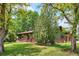 Charming single-story home with lush front yard, brick accents, and mature trees at 850 Idalia Cir, Aurora, CO 80011