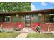 Inviting front porch with decorative plants and cozy seating, enhanced by brick accents at 850 Idalia Cir, Aurora, CO 80011