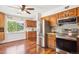 Eat-in kitchen features wood cabinets, stainless steel appliances and hardwood floors at 850 Idalia Cir, Aurora, CO 80011