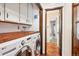 Functional laundry room with white cabinets, wood countertop and modern washer and dryer at 850 Idalia Cir, Aurora, CO 80011