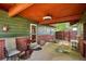 Covered outdoor space with seating, red ceiling and easy access to the home's entrance at 850 Idalia Cir, Aurora, CO 80011