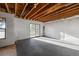 Unfinished basement featuring a sliding door and a window, with the ceiling rafters exposed at 12071 S Tallkid Ct, Parker, CO 80138