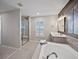 Relaxing bathroom with a soaking tub, glass shower, and vanity with great natural light at 12071 S Tallkid Ct, Parker, CO 80138