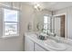 Bright bathroom with a double vanity, a large window, and modern fixtures at 1884 Westport Ave, Berthoud, CO 80513