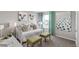 Bright bedroom with neutral walls and a large decorative art display at 1884 Westport Ave, Berthoud, CO 80513
