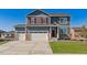Charming two-story home featuring a three-car garage and well-manicured lawn at 1884 Westport Ave, Berthoud, CO 80513