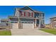 Charming two-story home featuring a three-car garage and well-manicured lawn at 1884 Westport Ave, Berthoud, CO 80513