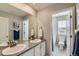 Bright bathroom featuring double sinks, neutral wall color and tile flooring at 14067 Hudson St, Thornton, CO 80602