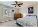 Cozy bedroom featuring a ceiling fan, carpet flooring and a chest of drawers at 14067 Hudson St, Thornton, CO 80602
