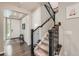 Elegant entryway featuring hardwood floors, staircase with dark wood railing and carpeted steps at 14067 Hudson St, Thornton, CO 80602