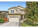 Inviting two-story home with a manicured lawn, charming front porch, and attached two-car garage at 14067 Hudson St, Thornton, CO 80602