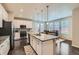 Bright kitchen features a large island with granite countertops and stainless steel appliances at 14067 Hudson St, Thornton, CO 80602