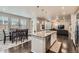 Open floor plan flows from the kitchen island to the dining area and living room at 14067 Hudson St, Thornton, CO 80602