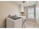 Convenient laundry room featuring side by side washer and dryer and overhead storage at 14067 Hudson St, Thornton, CO 80602