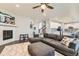 Spacious living room featuring a gray sectional, hardwood floors, fireplace, and view to the kitchen at 14067 Hudson St, Thornton, CO 80602